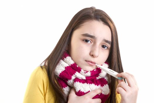 A young girl is sick and having her temperature taken.