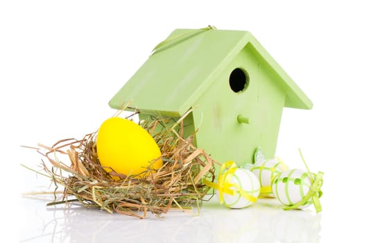 Easter eggs with birdhouse, on a white background