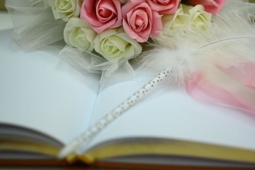 rings and beautiful flower bouquet on wedding notebook for guest