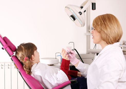 scared little girl and dentist