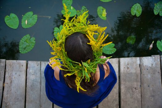 girl by the lake with a wreath on head