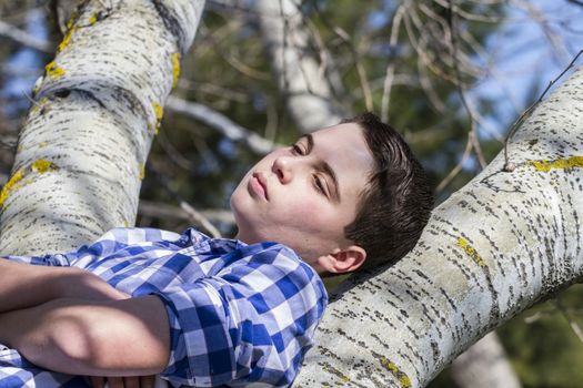 Handsome.A young boy dressed in western attire, outdoor park, summer