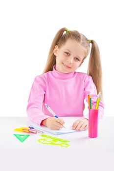 litle schoolgirl at table writing