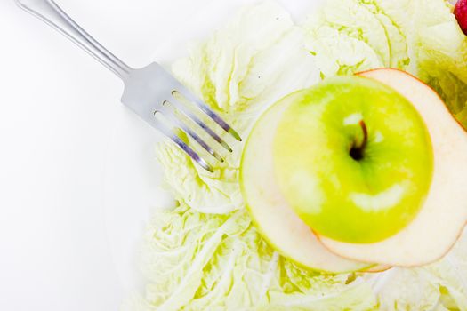 plate with salad and apples. vegetarian food