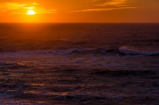 Sunset over the North Sea on a windy day with waves