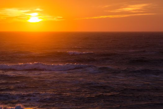 Sunset over the North Sea on a windy day with waves