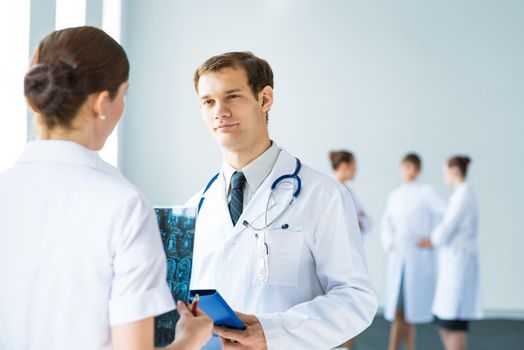 Doctor talking with a colleague, collaboration in medicine