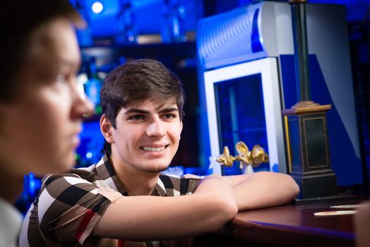 portrait of a young man at the bar, fun nightlife