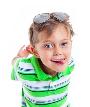 Portrait of a grimacing boy with sunglasses and wearing green clothing. Isolated on white background