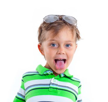 Portrait of a grimacing boy with sunglasses and wearing green clothing. Isolated on white background