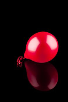 Red ballon with reflection on black background