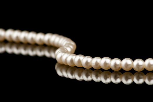 Pearl necklace cloeseup with reflection on black background