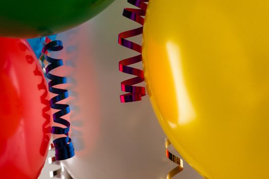 close up of colored party balloons and streamers