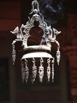 smoking incense on a bell in the buddhist temple       