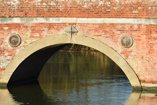 single arch of red brick bridge