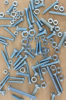 Hardware fixings isolated on a wooden bench