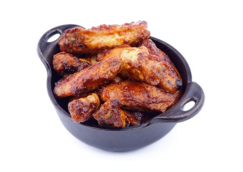 Hot Chicken Legs and Wings Barbecue in Black Saucepan isolated on White background