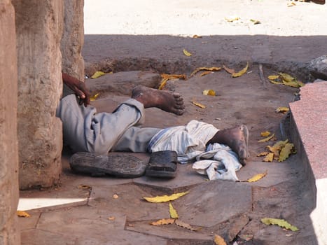 poor man sleeping on the street of New Delhi India        