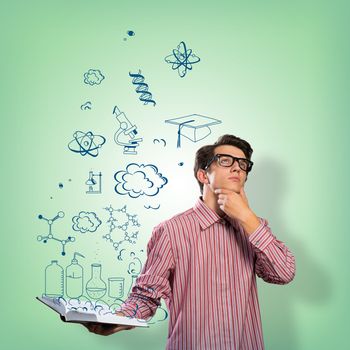 young scientist holding a book, fly out different ideas. concept of creativity