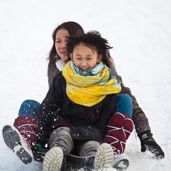 Girl sledging in winter in Denmark