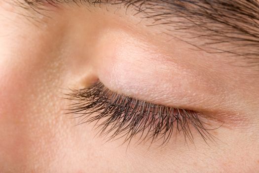 shoot of beautiful teenager man closed eye macro