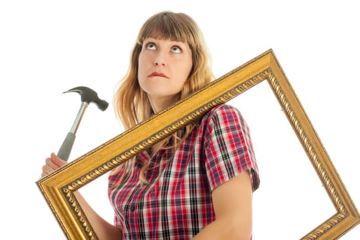 Young woman with frame and hammer on white background