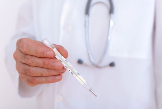 Close-up of doctor's hands showing thermometer