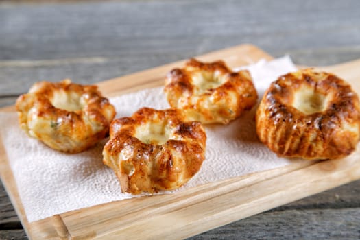 Soft newly-baked rolls on an old kitchen table