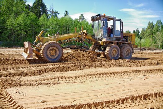 The grader clears away a ground In the afternoon