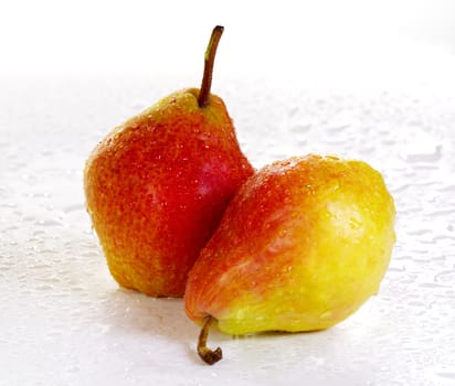 Two yellow-red pears on a white background