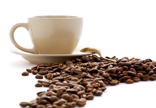 Cup and coffee grains isolated on a white background