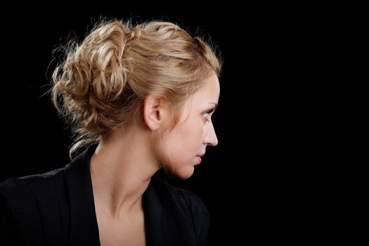 Portrait of the girl in a suit looking aside