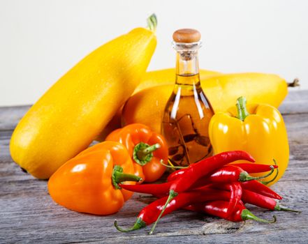 Still-life from chilli pepper and vegetables on an old table