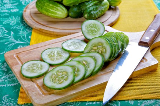 Still-life with the cut cucumbers an onions and garlic