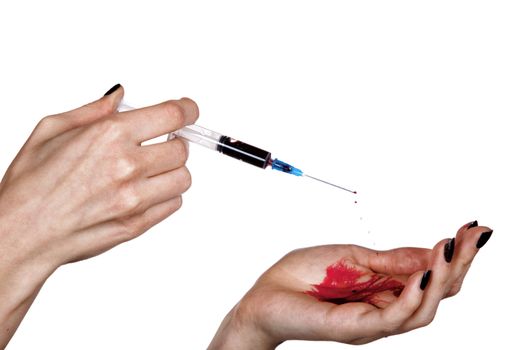 Hands of the addict about a syringe isolated on a white background