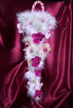 Wedding bouquet with orchids against a fabric