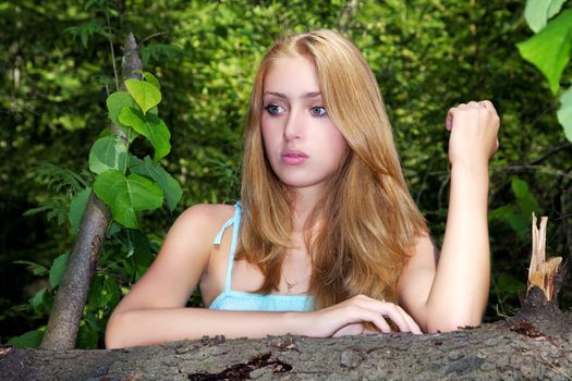 Portrait of the girl  in forest against trees