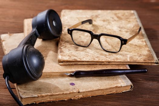 Still-life with old writing-books a nib and phone