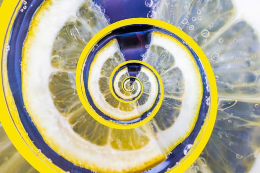 A spiral pattern of a slice of lemon in a glass