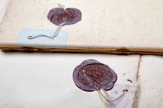 Two sealing wax press on old writing-books