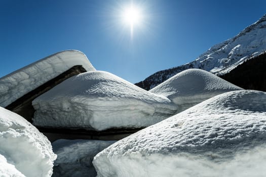 Macugnaga, snow above the roofs of the old houses - Piedmont, Italy