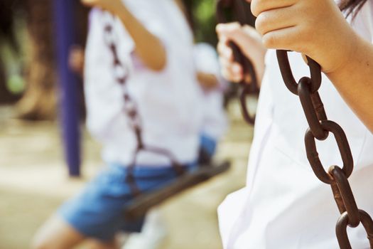 child swinging at a playground