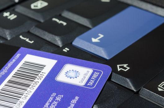 MUNICH, GERMANY - FEBRUARY 24, 2014: Tax free company Global Blue card on black notebook keyboard.