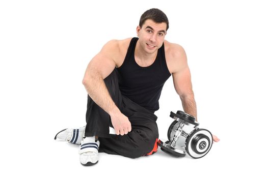 young man posing with dumbbells sitting on floor, on white background