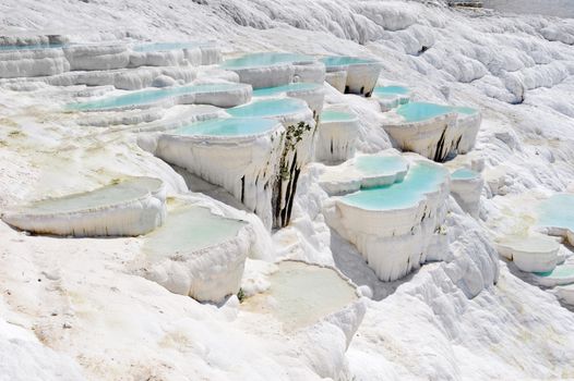 Blue cyan water travertine pools at ancient Hierapolis, now Pamukkale, Turkey