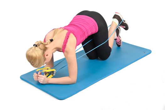 Young blond girl doing kneeling butt blaster exercise using rubber resistance band. position 1 of 2.