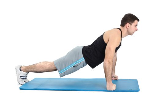 young man performing push-ups exercise on fists, on white background