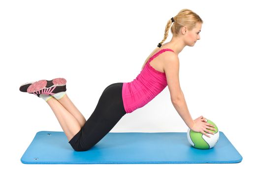 Young blond woman doing pushups on medicine ball
