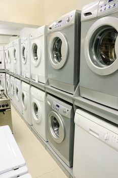 rows of washing machines selling in appliance store