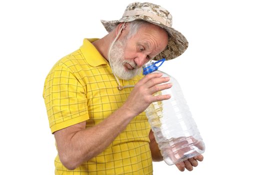 senior bearded man looks into empty plastic bottle
